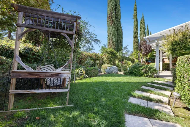 a view of a chairs and tables in the patio along with potted plants