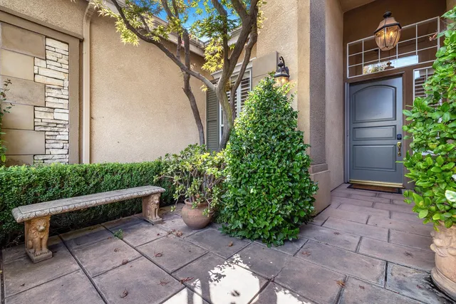 a wooden bench sitting in backside of a house