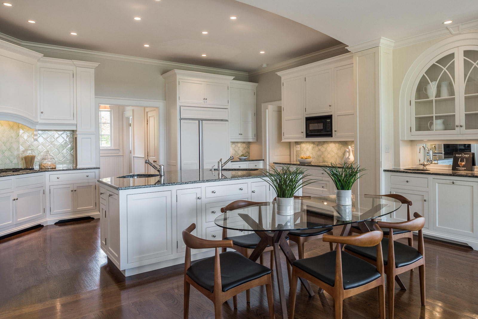 84 Turtle Back Road New Canaan, CT 06840 - Photo 11 of 35 a kitchen with white cabinets and stainless steel appliances