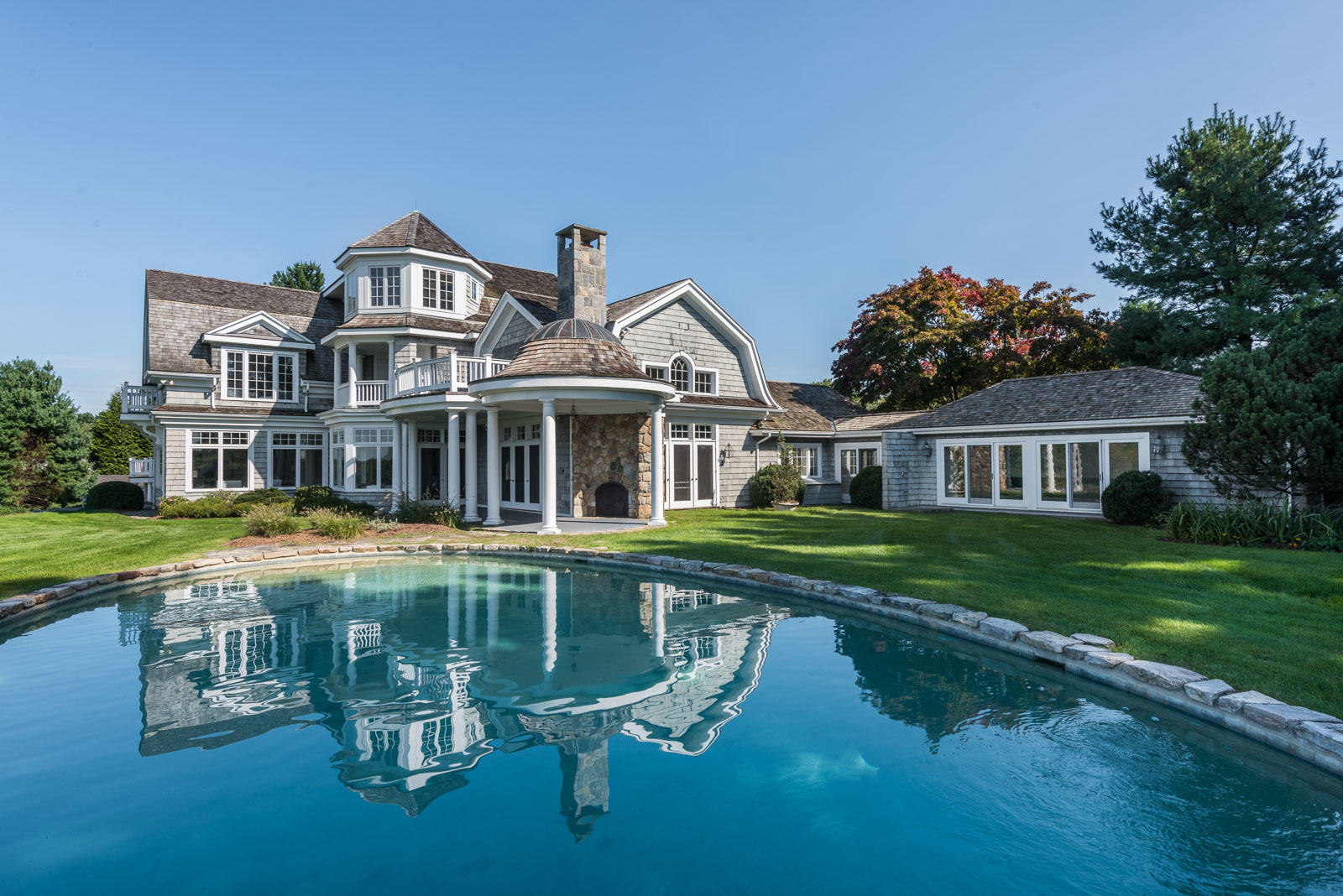 84 Turtle Back Road New Canaan, CT 06840 - Photo 27 of 35 a front view of a house with swimming pool having outdoor seating