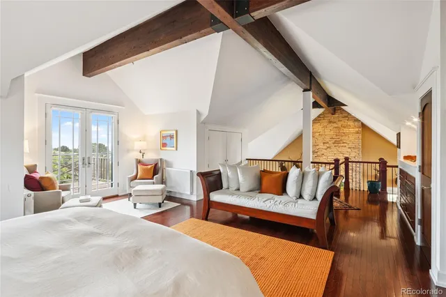a bedroom with furniture and wooden floor