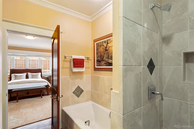 a bathroom with a tub and shower