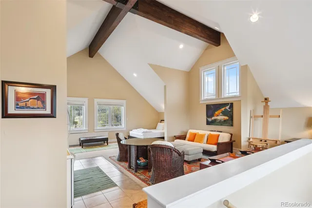 a kitchen with a dining table chairs and refrigerator