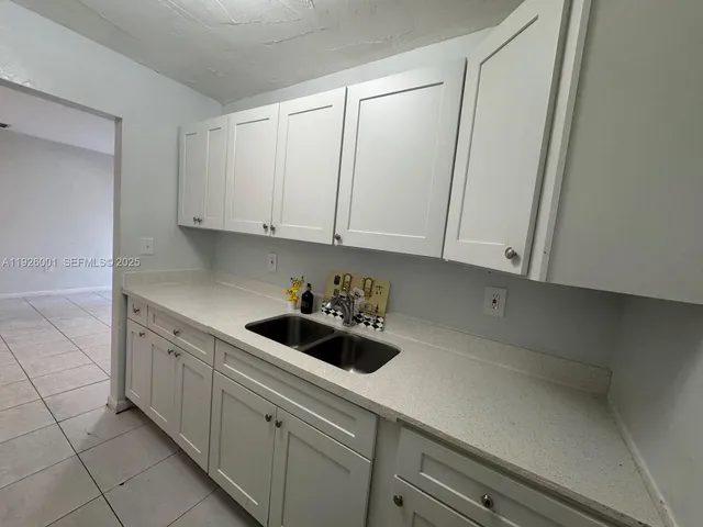 a kitchen with a sink and cabinets