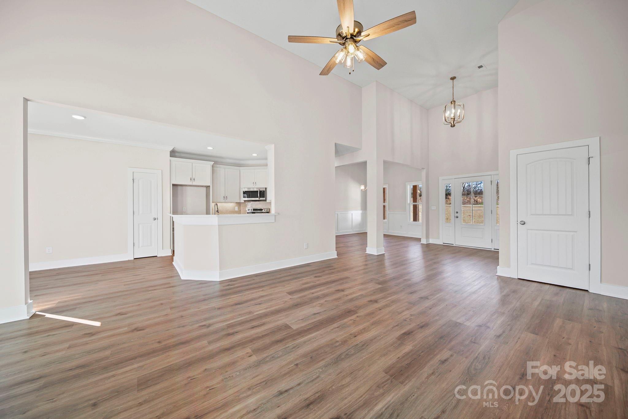 4106 New Salem Road Marshville, NC 28103 - Photo 11 of 46 a view of a big room with wooden floor and a kitchen