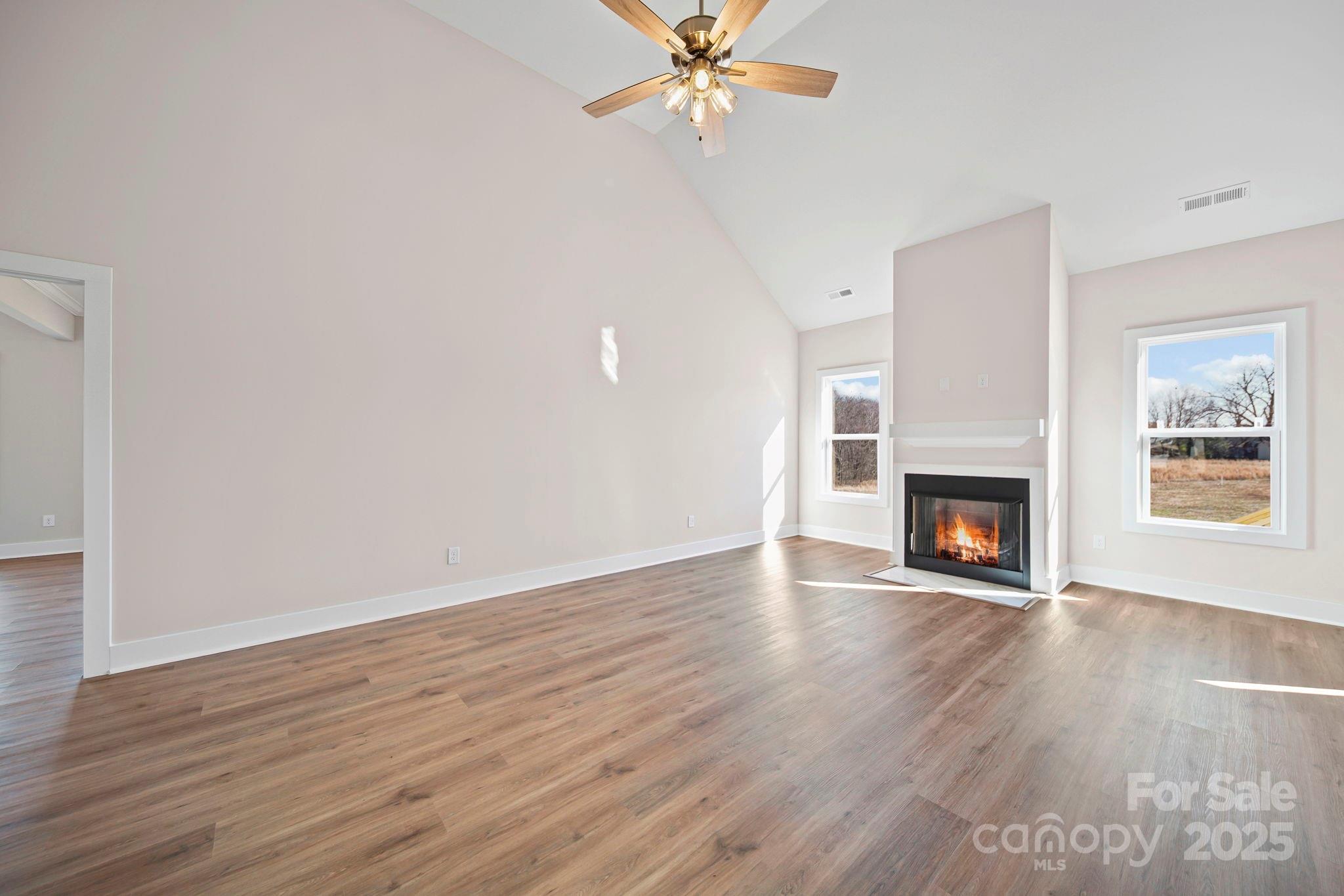 4106 New Salem Road Marshville, NC 28103 - Photo 13 of 46 a view of an empty room with wooden floor fireplace and a window