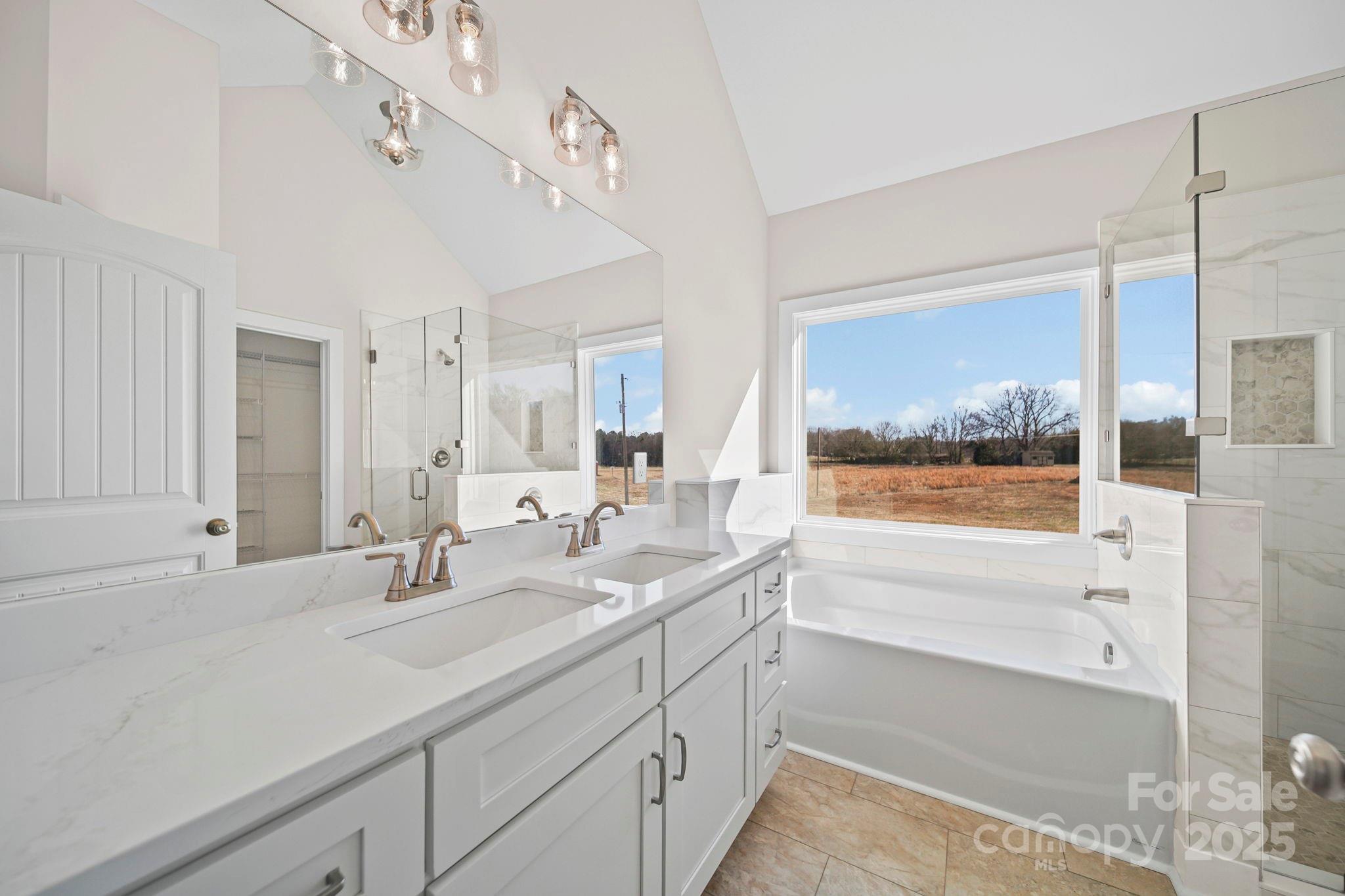 4106 New Salem Road Marshville, NC 28103 - Photo 29 of 46 a bathroom with a sink and a large mirror