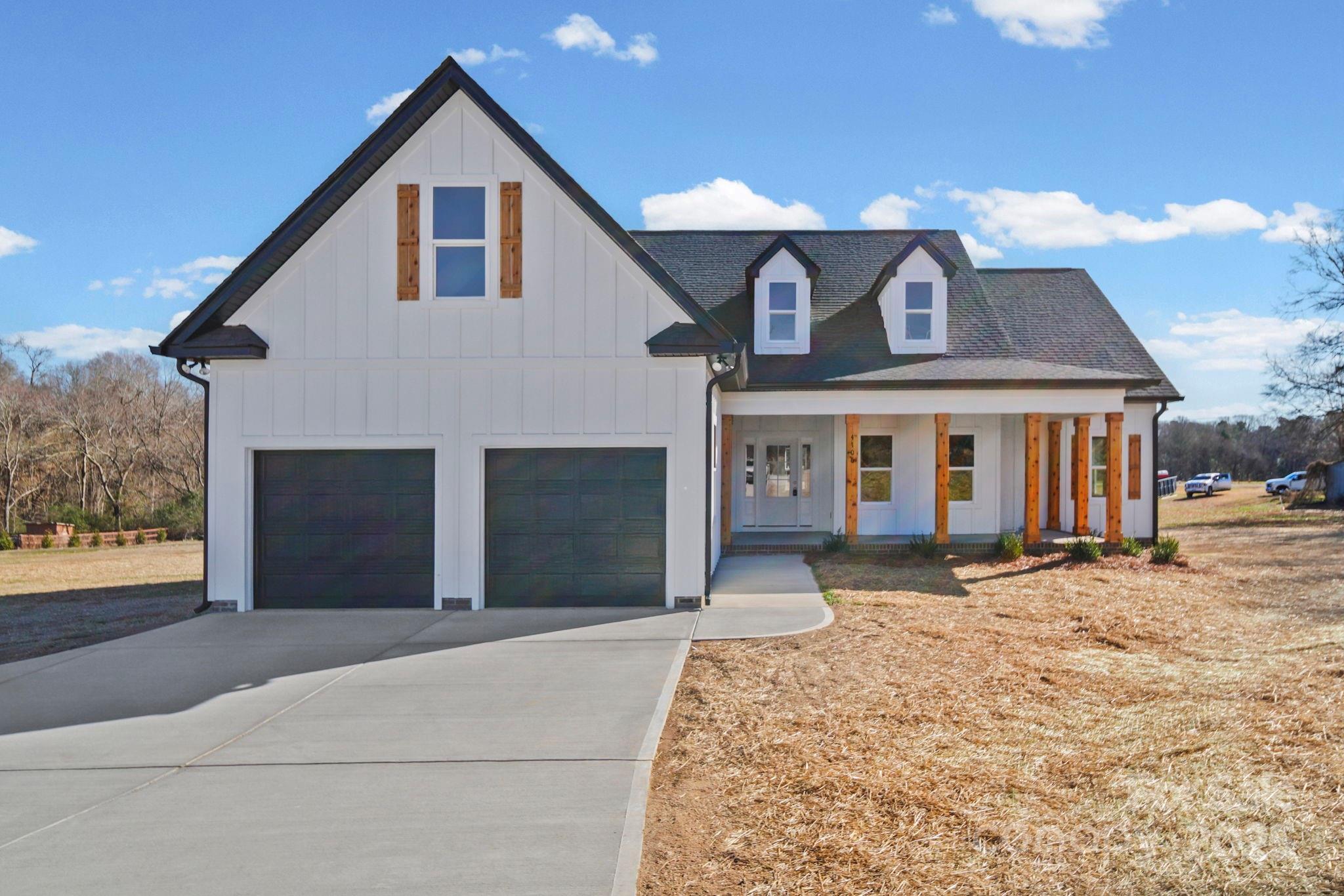 4106 New Salem Road Marshville, NC 28103 - Photo 3 of 46 a front view of a house with a yard and garage