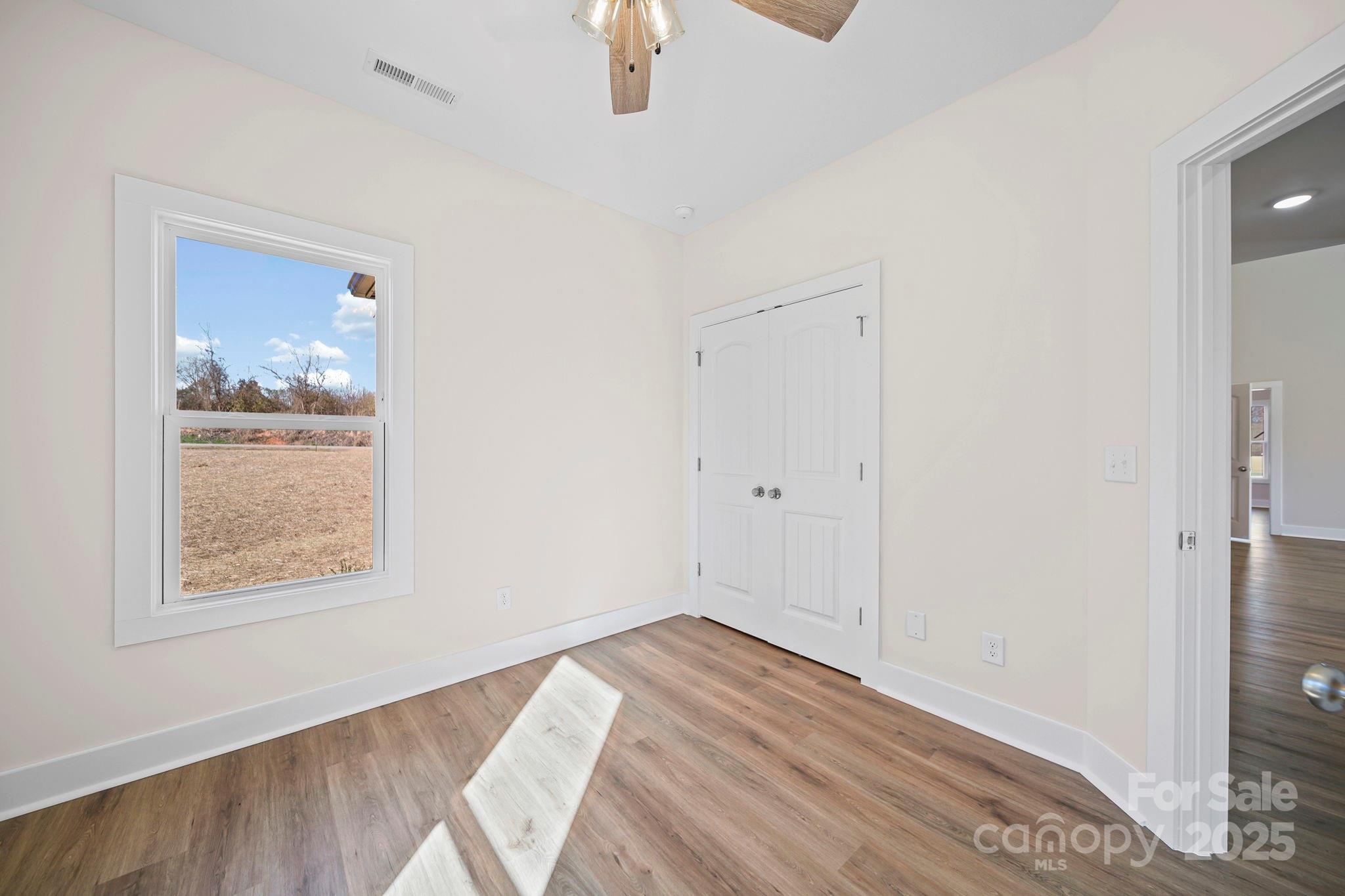 4106 New Salem Road Marshville, NC 28103 - Photo 35 of 46 a view of empty room with wooden floor and fan