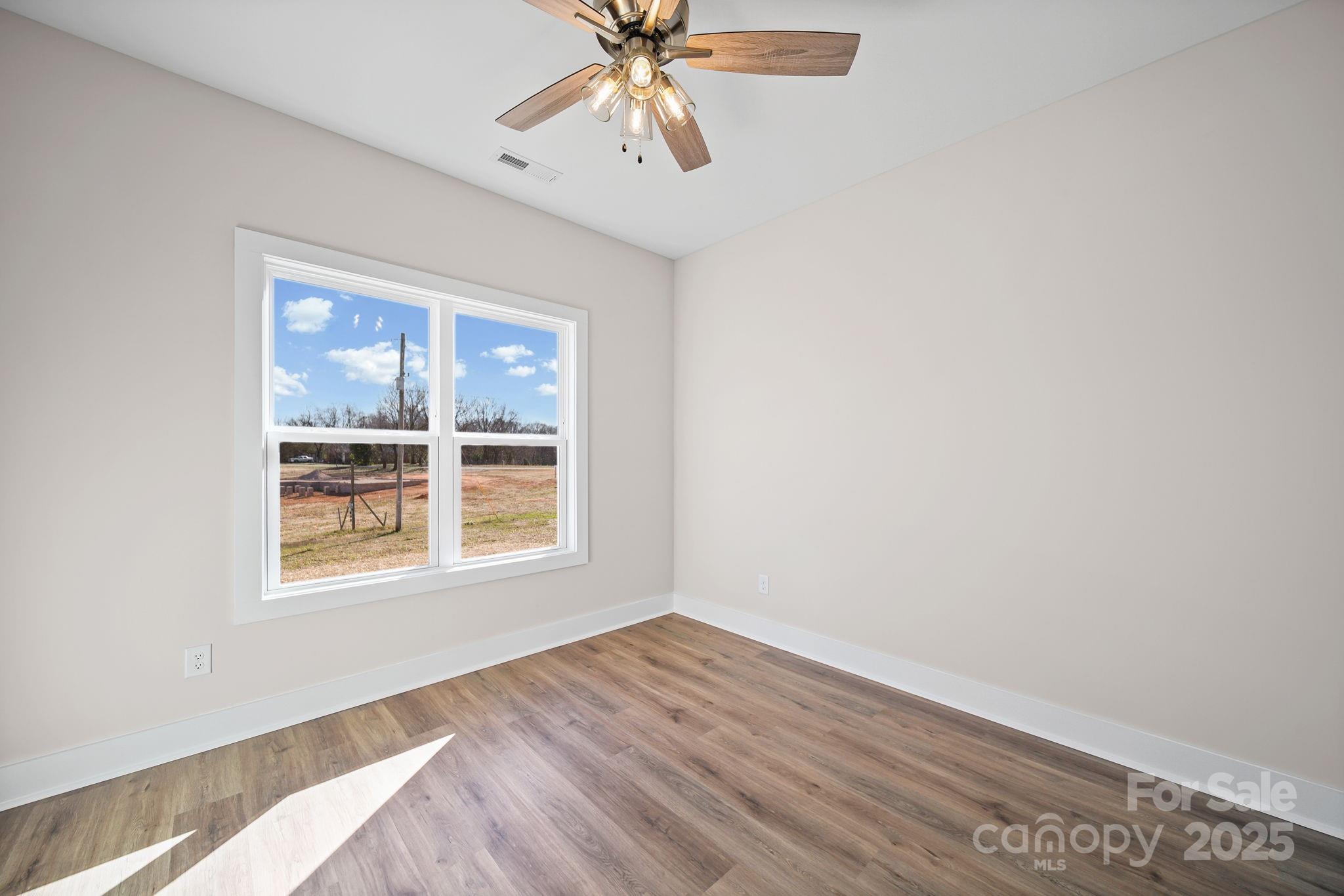 4106 New Salem Road Marshville, NC 28103 - Photo 37 of 46 a view of an empty room with wooden floor and a window