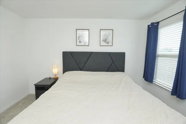 a bedroom with a bed and a window