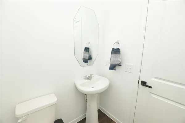 a bathroom with a sink a toilet and mirror
