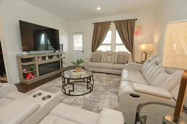 a living room with furniture and a flat screen tv