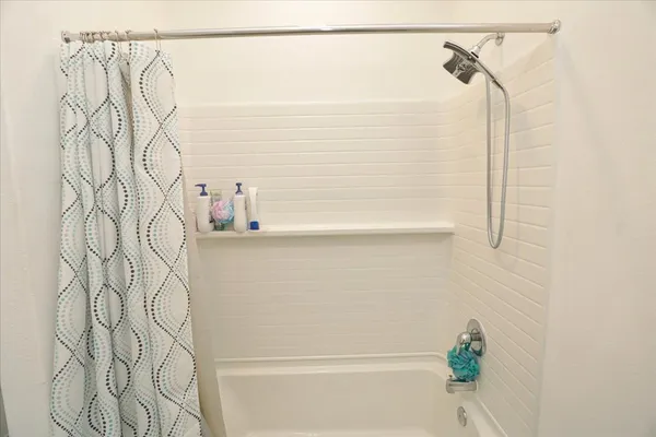 a bathroom with a shower and a shower curtain