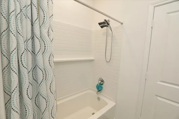 a bathroom with a bathtub and shower