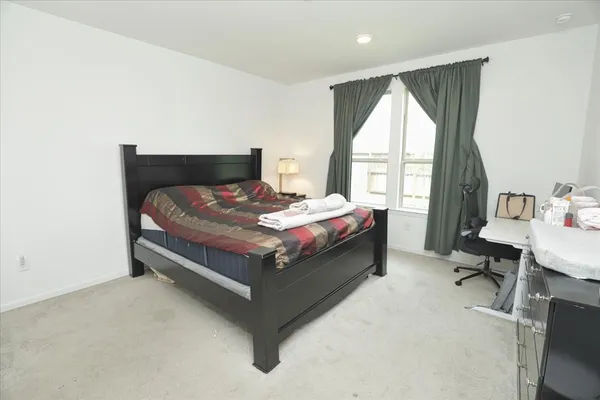 a bed sitting in a bedroom next to a window