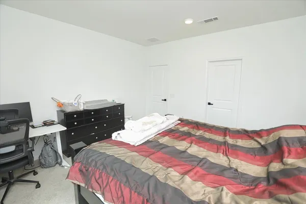 a bedroom with a bed and a desk