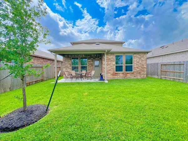 a view of a house with a backyard porch and sitting area