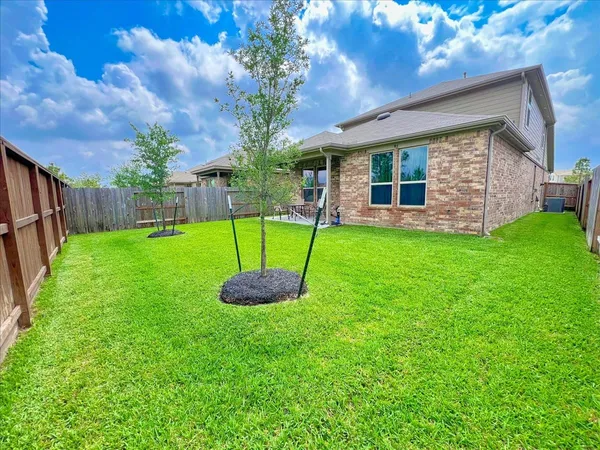 a view of a house with a backyard and porch