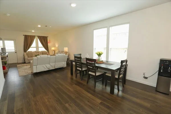 a view of a dining room with furniture and wooden floor