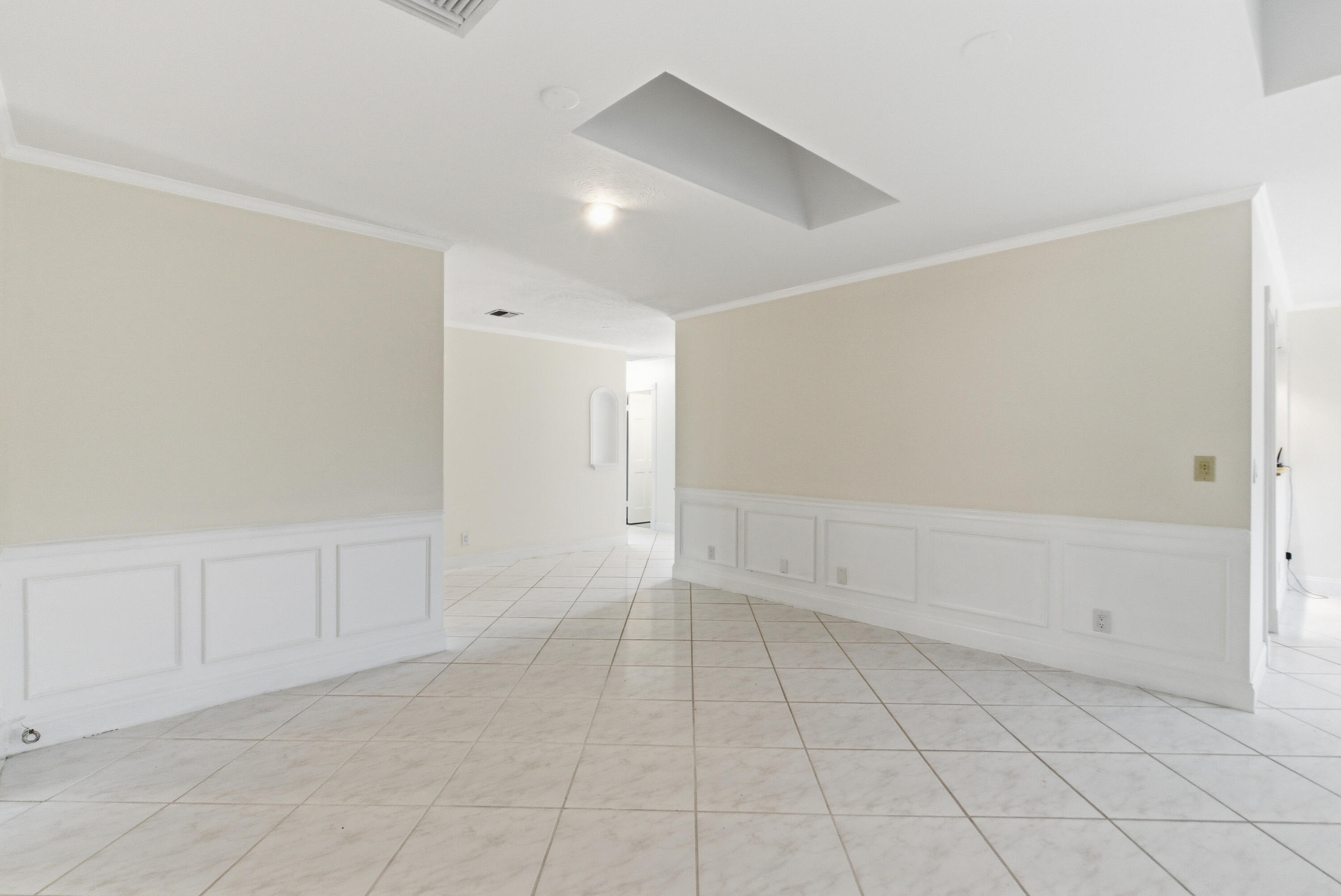 5151 Southeast Burning Tree Circle Stuart, FL 34997 - Photo 20 of 74 an empty room with white walls and tiles