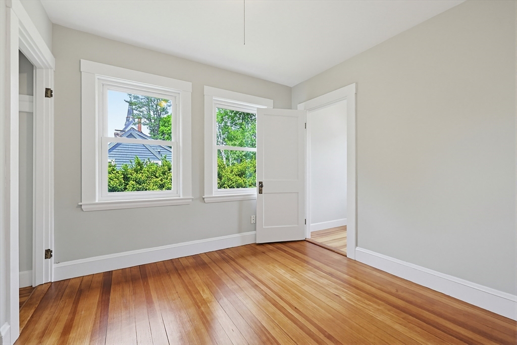 10 Water Street Natick, MA 01760 - Photo 19 of 35 an empty room with wooden floor and windows