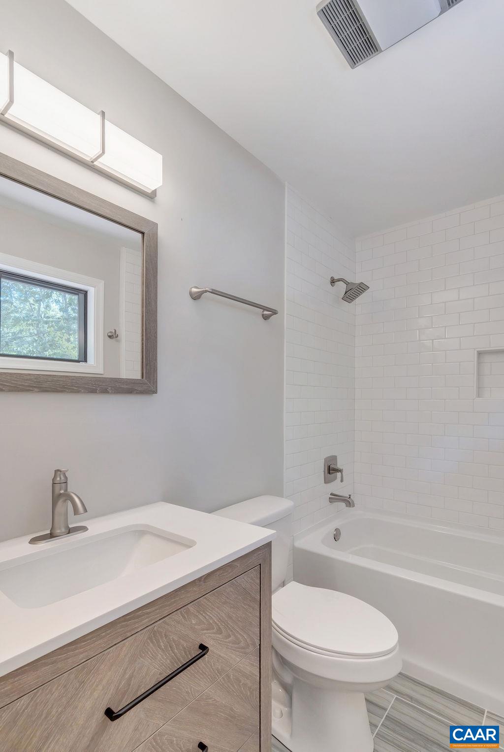 26 Dogleg Road Palmyra, VA 22963 - Photo 16 of 48 a bathroom with a sink a toilet and a bathtub