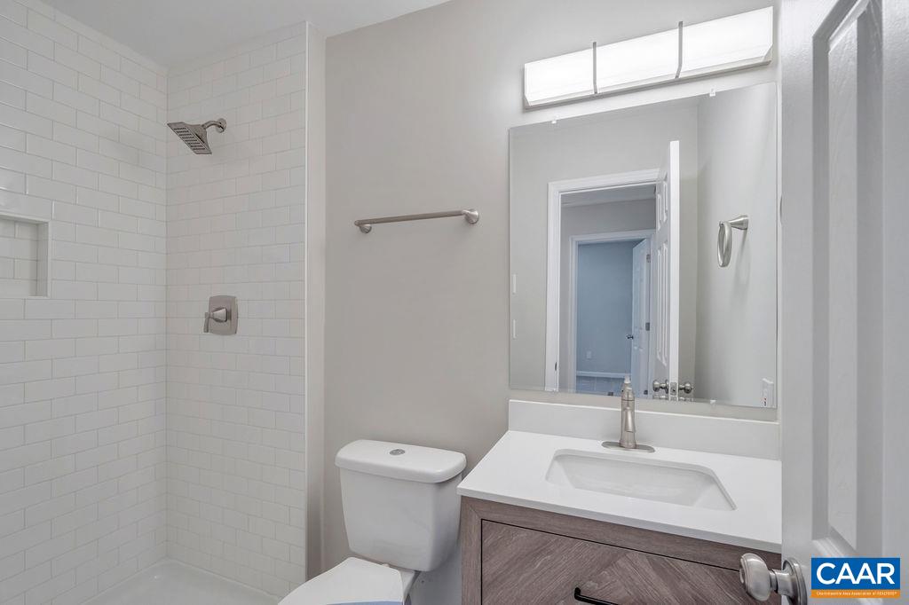 26 Dogleg Road Palmyra, VA 22963 - Photo 17 of 48 a bathroom with a sink toilet and vanity