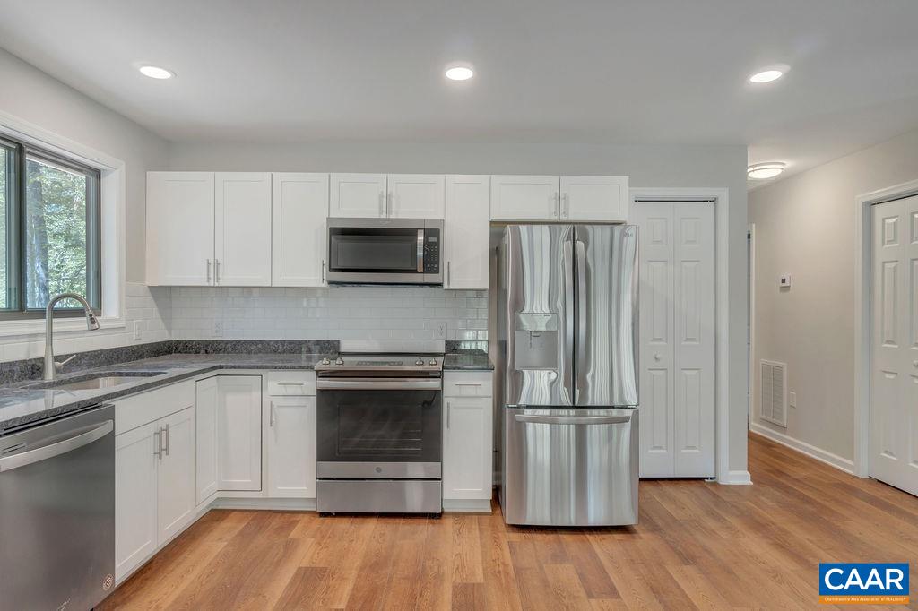 26 Dogleg Road Palmyra, VA 22963 - Photo 26 of 48 a kitchen with stainless steel appliances granite countertop a refrigerator microwave and stove