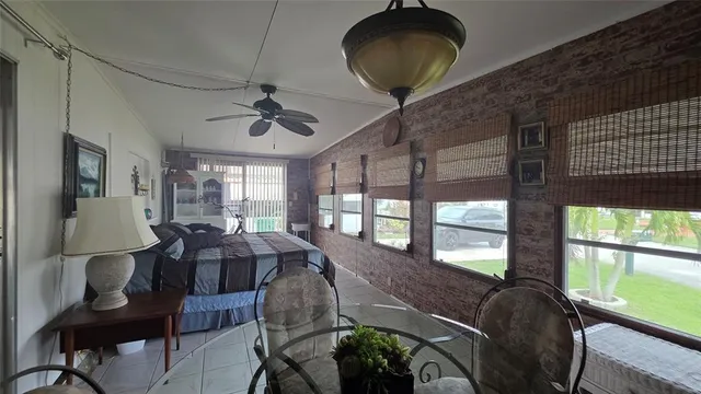 a bedroom with double bed and a large window