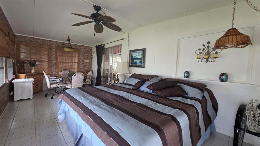 1931 Southwest 85th Avenue Davie, FL 33324 - Photo 23 of 35 a bed room with a bed and a chandelier