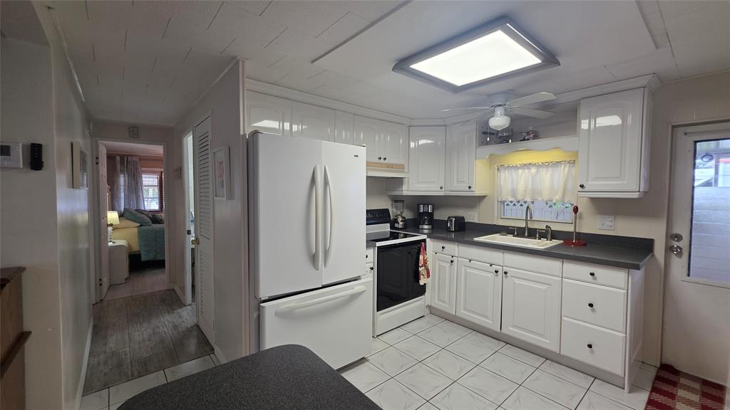 1931 Southwest 85th Avenue Davie, FL 33324 - Photo 24 of 35 a kitchen with granite countertop a refrigerator and a sink