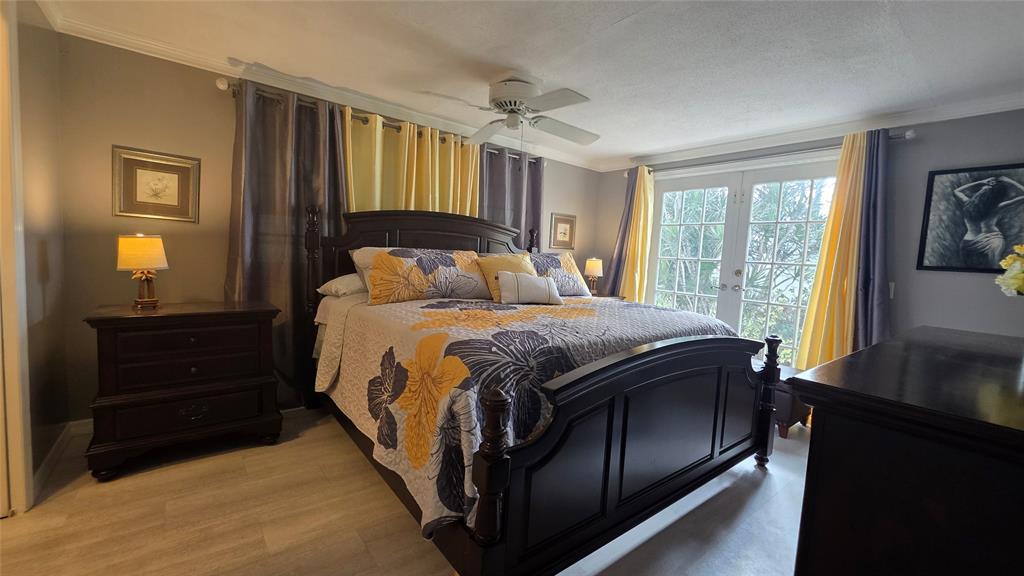 1931 Southwest 85th Avenue Davie, FL 33324 - Photo 27 of 35 a bedroom with a bed and a flat tv screen on dresser