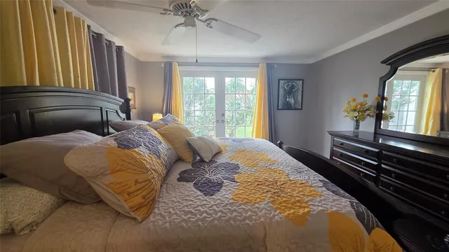 a spacious bedroom with a bed and a chandelier