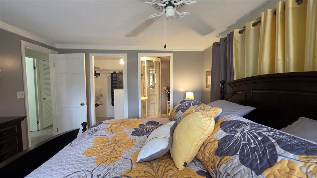 1931 Southwest 85th Avenue Davie, FL 33324 - Photo 32 of 35 a bed sitting in a bedroom next to a window and a chandelier