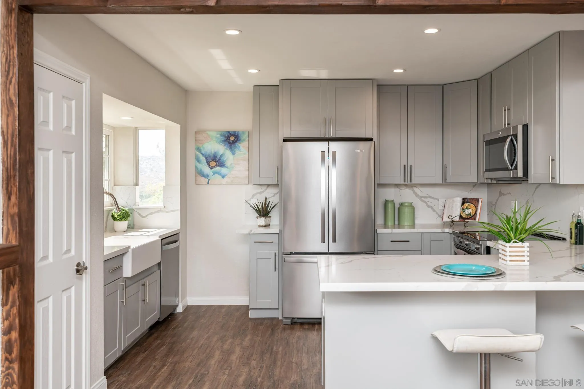 25511 Potrero Valley Road Potrero, CA 91963 - Photo 12 of 48 a kitchen with a refrigerator a sink and wooden cabinets