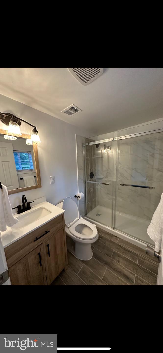 23794-23790 St Clair Road California, MD 20619 - Photo 16 of 20 a bathroom with a sink mirror toilet and shower