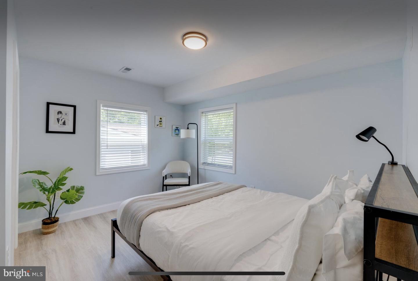 23794-23790 St Clair Road California, MD 20619 - Photo 4 of 20 a bedroom with a bed and a potted plant