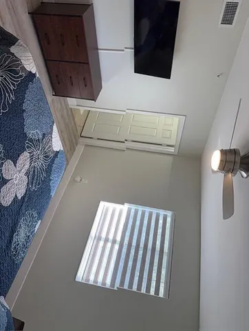 a view of a room with wooden floor