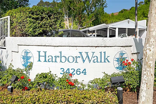 a sign that is in front of flowers