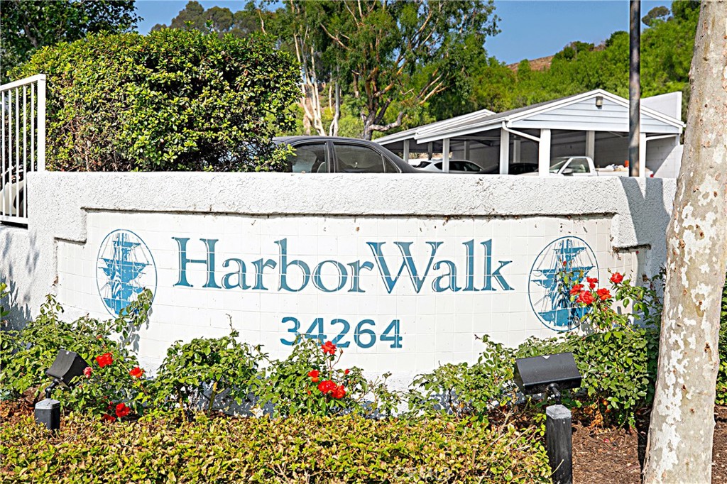 34264 Camino Capistrano, Unit 309 Dana Point, CA 92624 - Photo 1 of 35 a sign that is in front of flowers