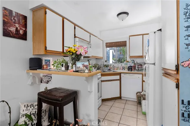 a kitchen with stainless steel appliances a sink and a refrigerator
