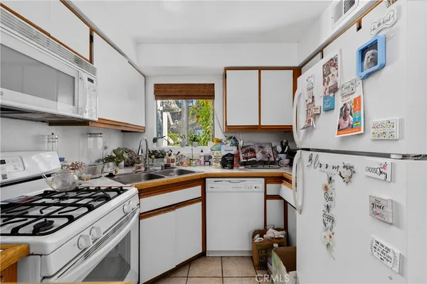 a kitchen with stainless steel appliances a stove a sink and a refrigerator
