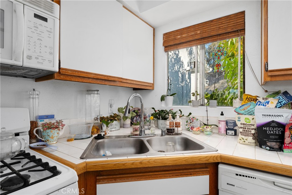 34264 Camino Capistrano, Unit 309 Dana Point, CA 92624 - Photo 15 of 35 a kitchen with a stove a sink and a cabinets