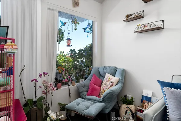a living room with furniture and flowers