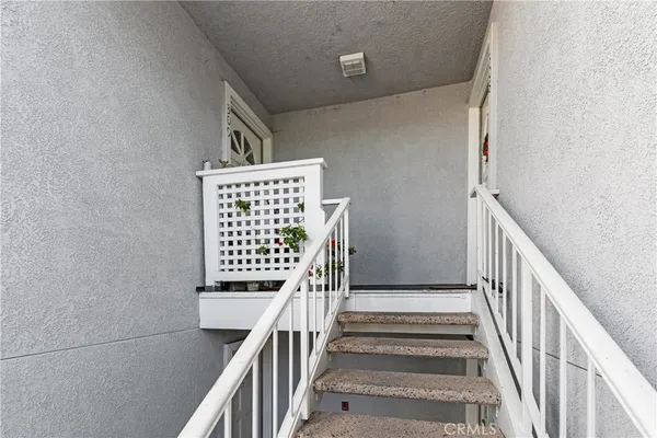 a view of staircase with railing and white walls