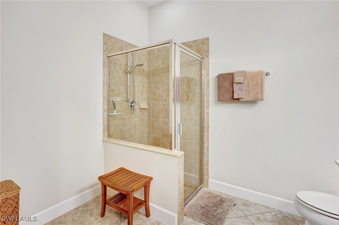 10879 Rutherford Road Fort Myers, FL 33913 - Photo 15 of 36 a bathroom with a toilet a sink and mirror