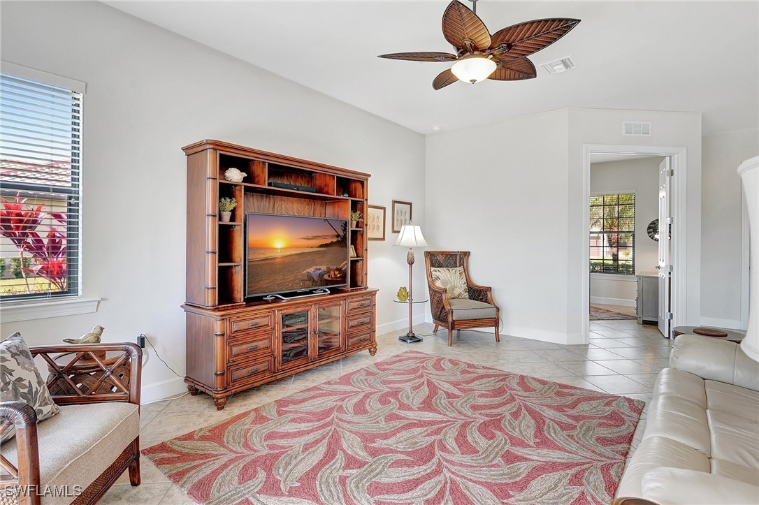 10879 Rutherford Road Fort Myers, FL 33913 - Photo 6 of 36 a living room with furniture and a flat screen tv