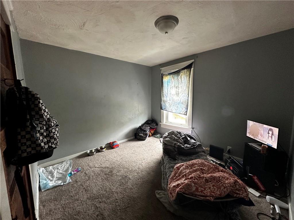 606 Chestnut Street New Castle, PA 16101 - Photo 11 of 12 a bed sitting in a bedroom next to a window