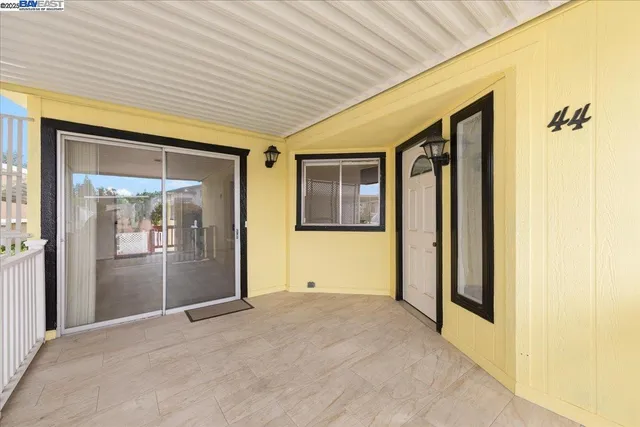 a view of a porch with wooden floor and a table